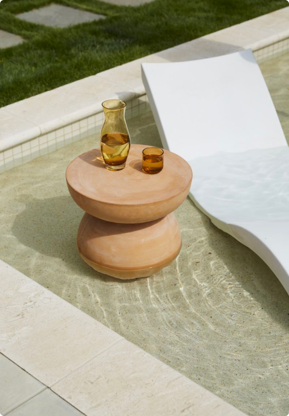 outdoor Thera stool in wading pool next to a lounger