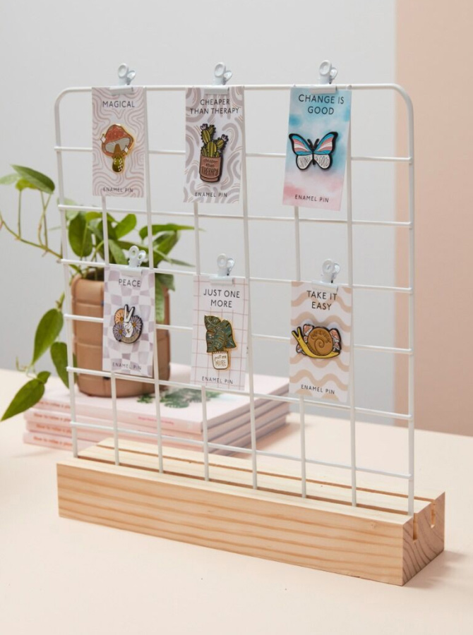 plant enamel pins on a white wire display rack